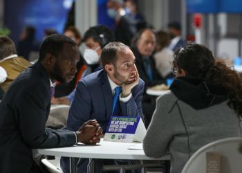 BIC representatives Peter Aburi and Daniel Perell in conversation with another COP 26 delegate. "Photo by Dan Perell