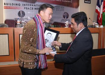 Presentation of token of appreciation by Mr. Hassan, Rector of UNIRA